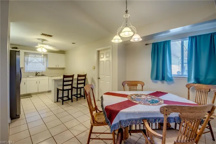 Dining area with light tile patterned flooring