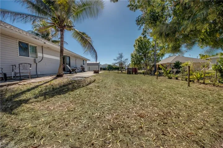 View of grassy yard featuring a patio