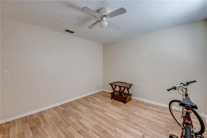 Empty room with light wood-type flooring and ceiling fan