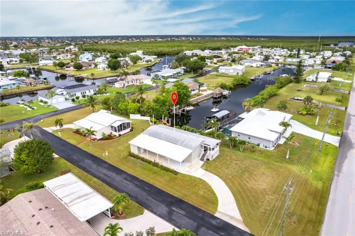 Aerial view of residential area featuring a nearby body of water