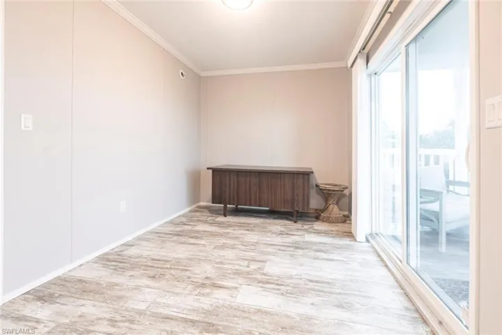Unfurnished room with light wood finished floors and ornamental molding