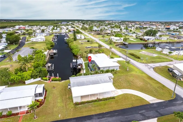 Aerial perspective of suburban area featuring a nearby body of water