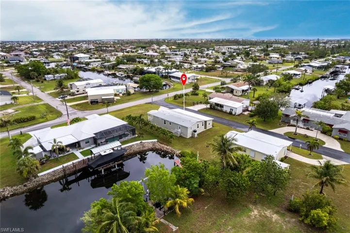 Aerial perspective of suburban area featuring a large body of water