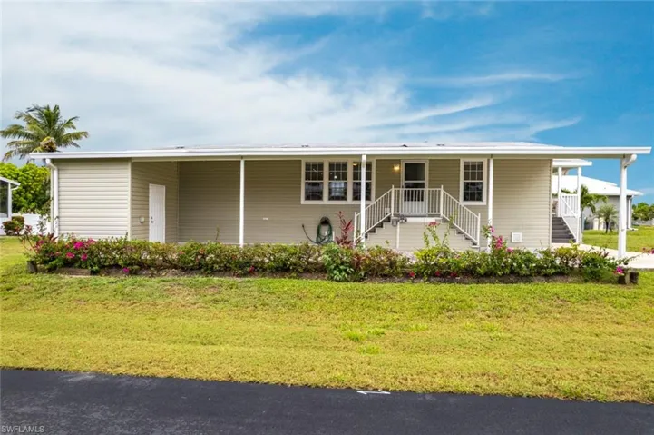 View of front of house featuring a front yard and a porch