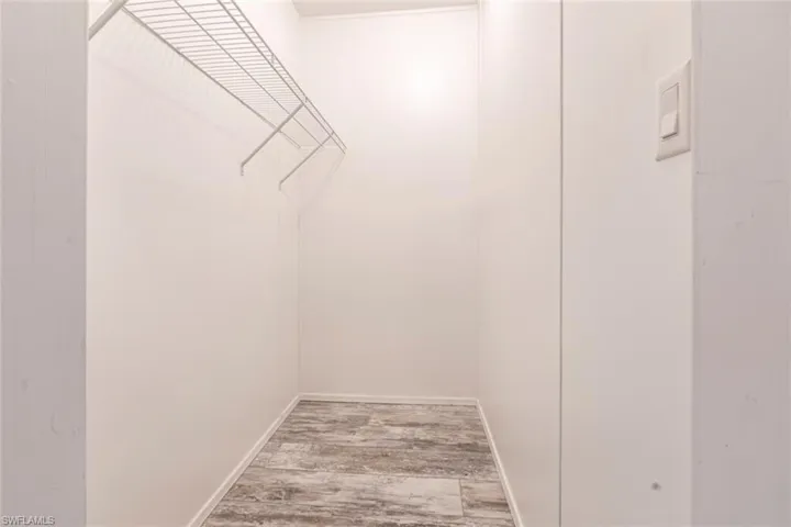 Walk in closet featuring light wood-style floors