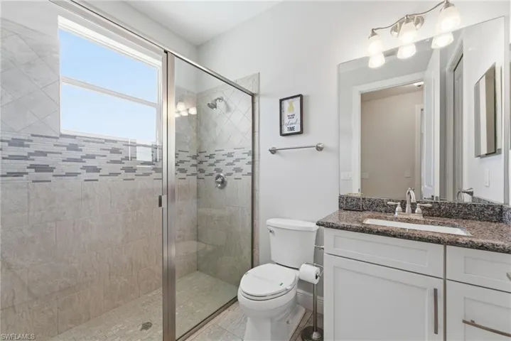 Bathroom with vanity and a shower stall