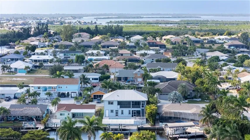 Aerial view of residential area featuring a large body of water