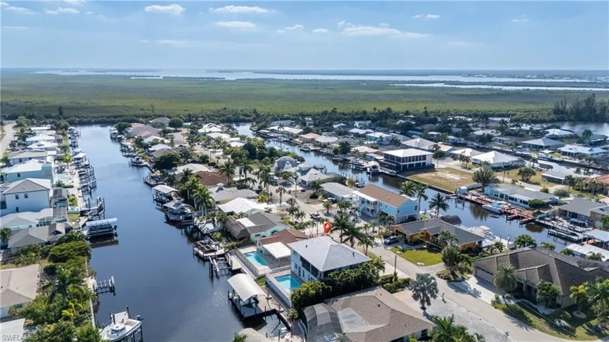 Aerial perspective of suburban area featuring a large body of water