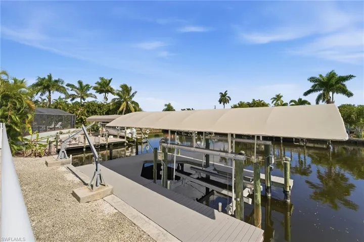 Dock area with boat lift and a water view