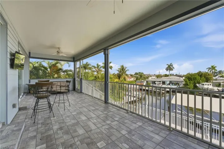 View of patio featuring a ceiling fan and a water view