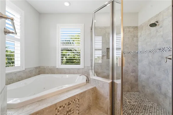 Full bathroom with a whirlpool tub, a stall shower, and recessed lighting