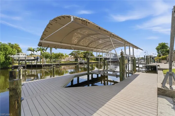 Dock with boat lift and a water view