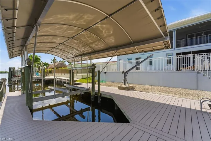 Dock area with boat lift and a water view