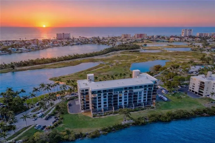 View of urban area with a large body of water and apartment complex / building