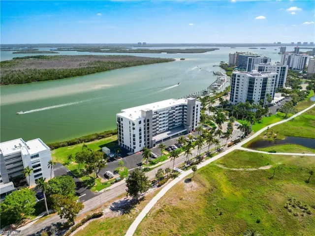 Bird's eye view of apartment complex and a nearby body of water
