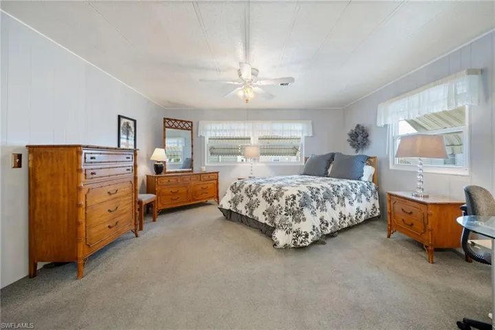 Bedroom with light colored carpet and ceiling fan