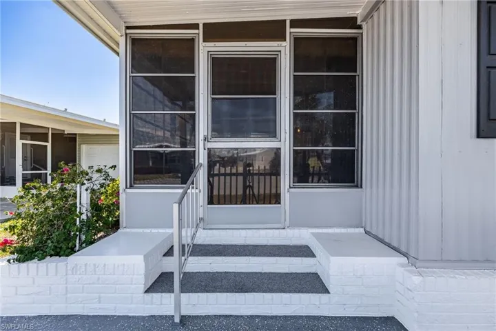 Doorway to property with a sunroom