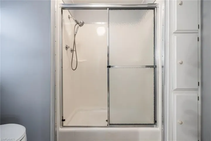 Full bath with a shower stall and toilet