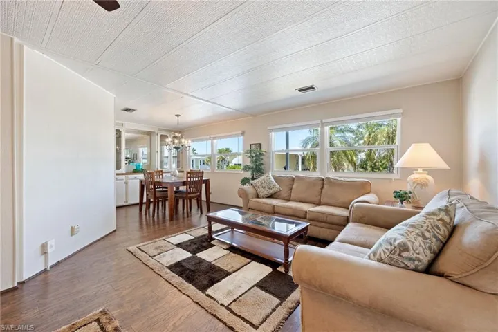 Living area with wood finished floors and hanging lights