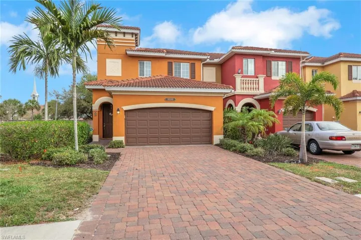 Mediterranean / spanish home with stucco siding, decorative driveway, an attached garage, and a tiled roof