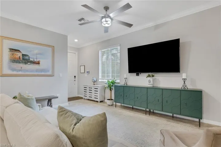 Living room featuring crown molding, ceiling fan, and recessed lighting