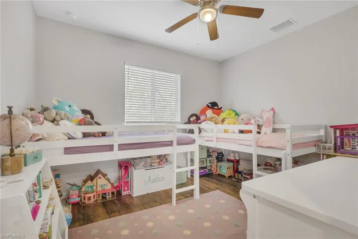 Bedroom with dark wood-style flooring and ceiling fan