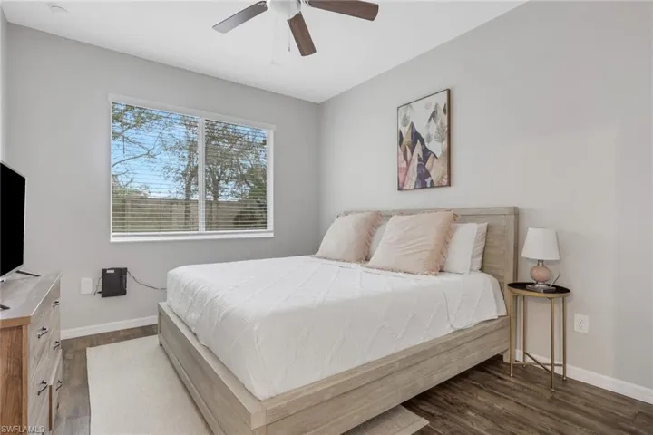 Bedroom with dark wood-style floors and ceiling fan