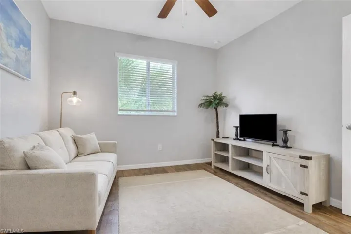 bedroom with a ceiling fan and light wood-type flooring