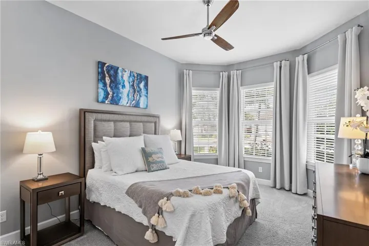 Bedroom with light colored carpet and ceiling fan
