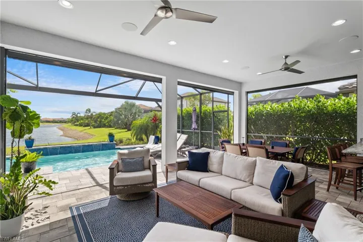 View of patio with a ceiling fan, outdoor lounge area, outdoor dining area, an outdoor pool, and a water view