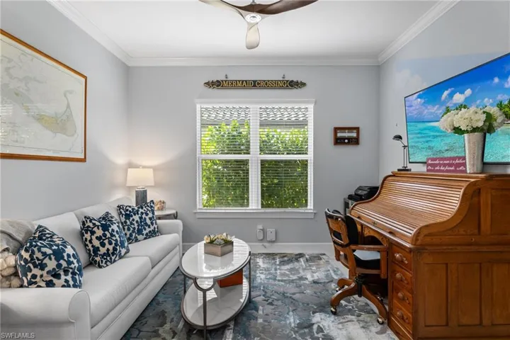Living room featuring ornamental molding and baseboards