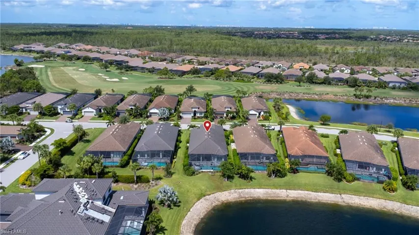 Aerial view of property and surrounding area with nearby suburban area and a local golf course