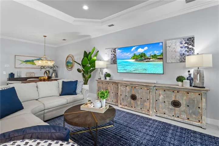 Living area with crown molding and recessed lighting