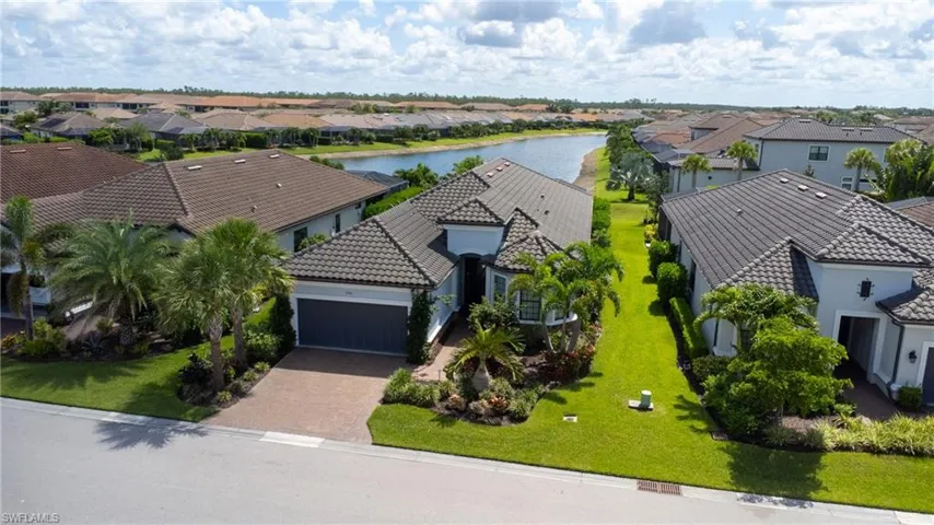 Aerial perspective of suburban area with a nearby body of water