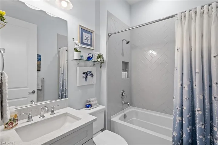 Bathroom featuring vanity and shower / tub combo