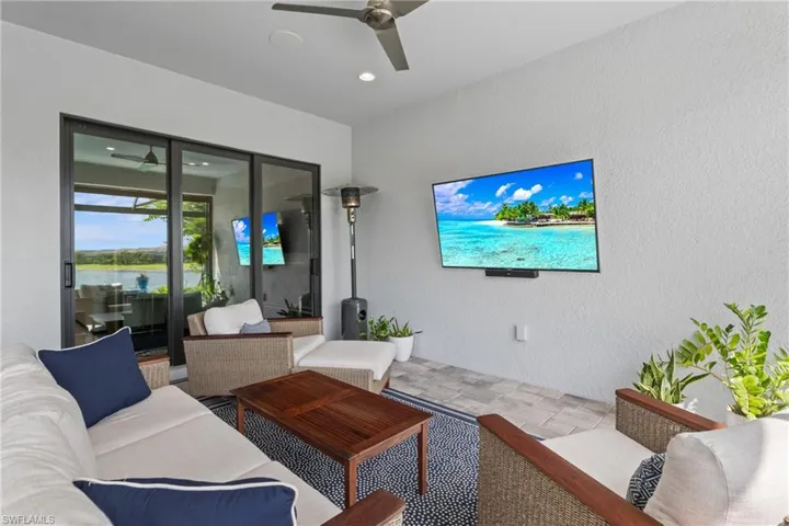 Living area with ceiling fan, a textured wall, and recessed lighting