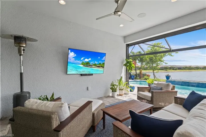 Living area featuring a sunroom, a textured wall, ceiling fan, and recessed lighting