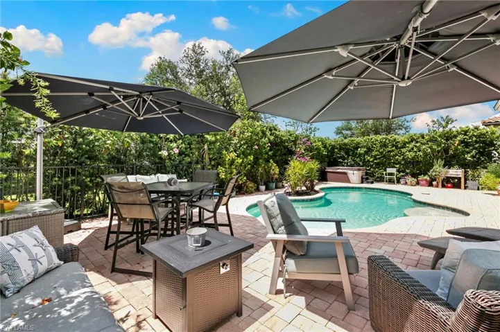 Paver patio with a freeform swimming pool and built-in spa