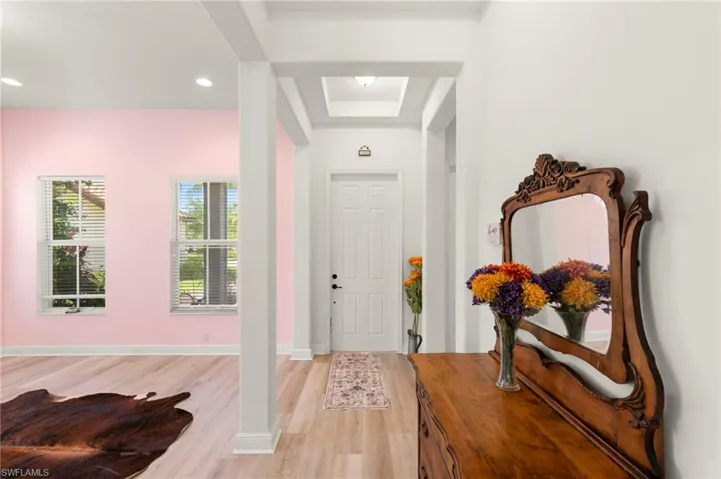 Entrance foyer featuring wood-finish flooring and a recessed ceiling detail