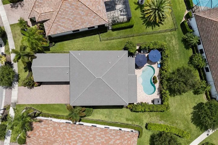 Aerial perspective showcasing a property with a gray tile roof and a private swimming pool