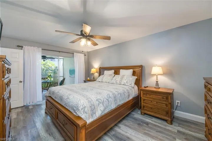 Bedroom featuring ceiling fan, access to exterior, and wood-type flooring