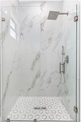 Bathroom featuring a marble finish shower