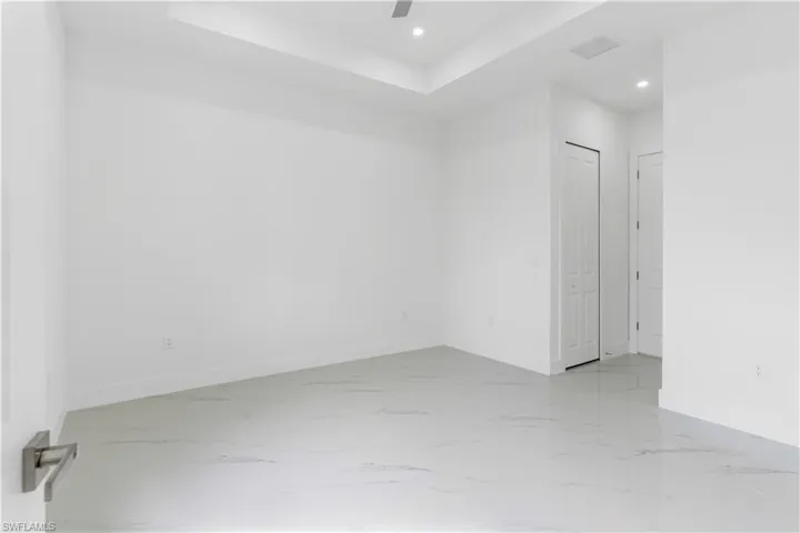 Spare room with recessed lighting, light marble finish flooring, and a ceiling fan