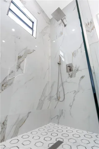 Full bathroom featuring a marble finish shower