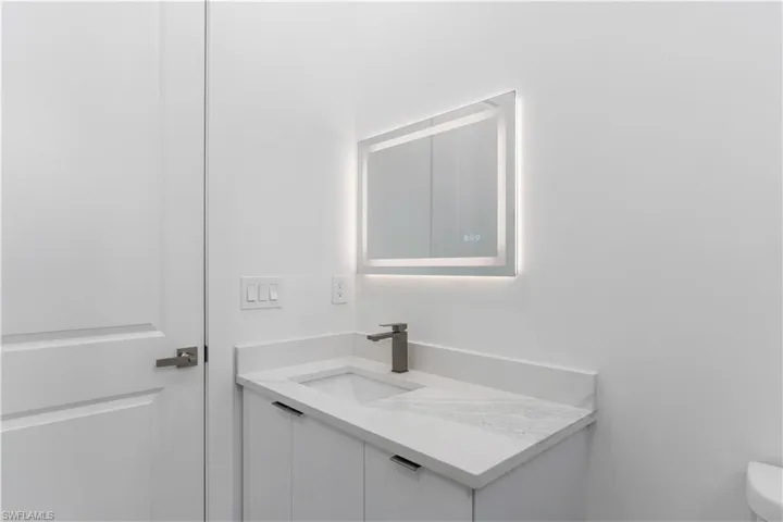 Half bath with vanity and toilet