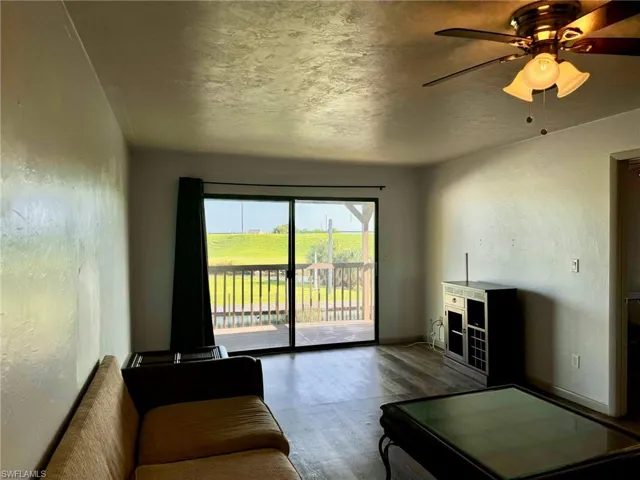 Unfurnished living room with hardwood / wood-style floors and ceiling fan