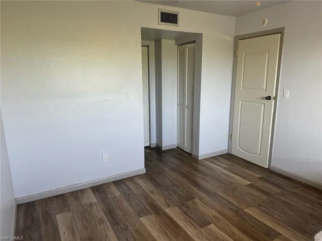 Unfurnished bedroom featuring wood-type flooring