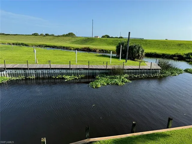 Dock area featuring a lawn and a water view