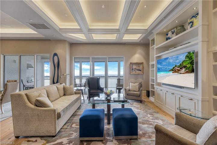 The formal living area overlooks the Gulf of Mexico and is open to the kitchen and dining room.