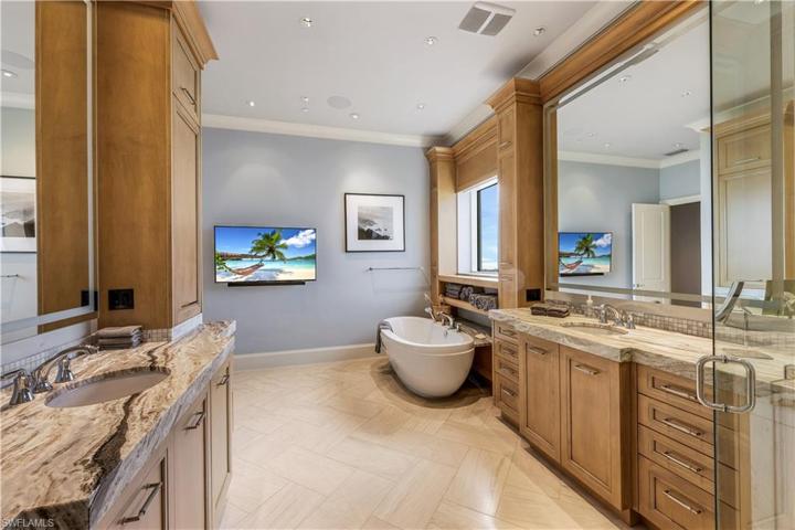 The primary en suite bathroom is grand in size with separate vanity areas, a soaking tub and a walk in shower.
